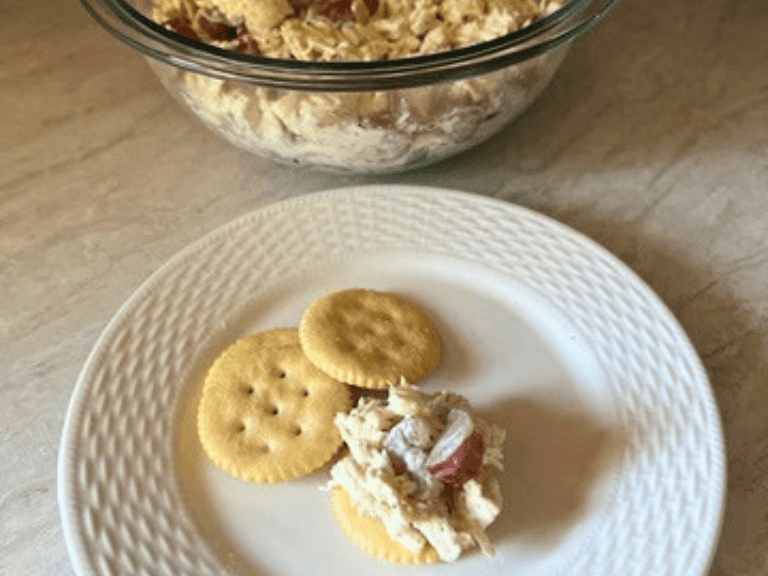 Creamy homemade chicken salad served on crackers for an easy snack or appetizer.