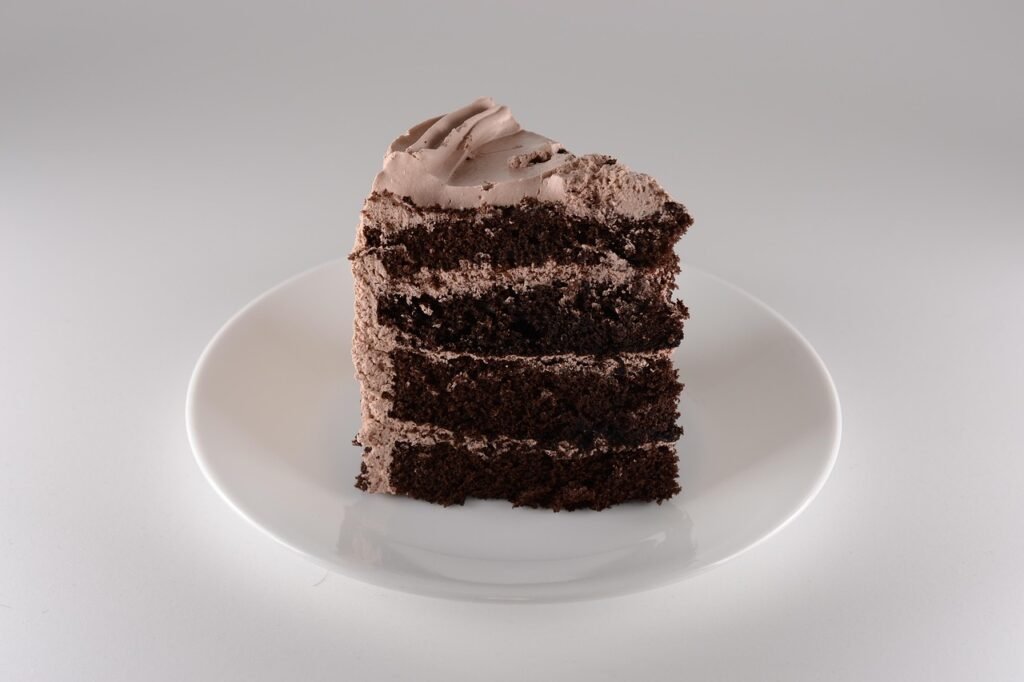 Slice of chocolate espresso cake with cream cheese frosting on a plate