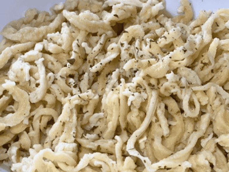 Traditional German spaetzle noodles served in a bowl with butter and herbs