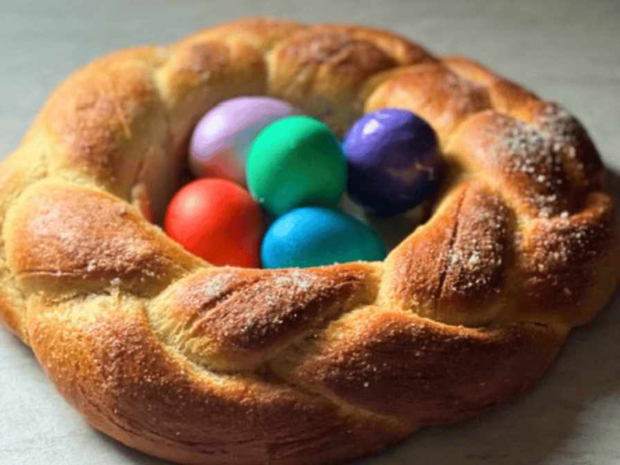 Braided German Hefekranz Easter bread shaped into a wreath with colored eggs in the center