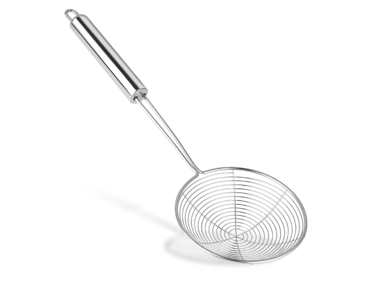 Stainless steel spider strainer skimmer lifting freshly cooked homemade spaetzle from a pot of boiling water
