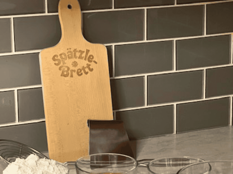 Weis wooden spaetzle board with stainless steel scraper used to make traditional homemade German spaetzle.