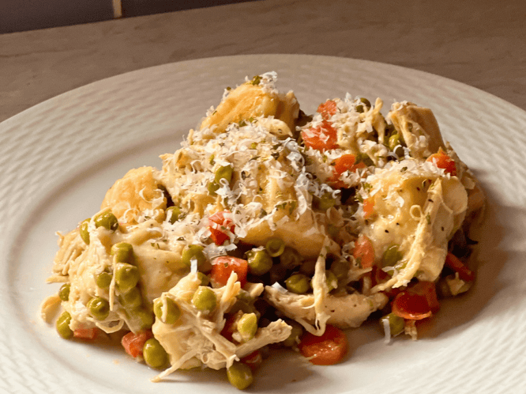 Plate of slow cooker chicken and dumplings topped with Parmesan cheese,