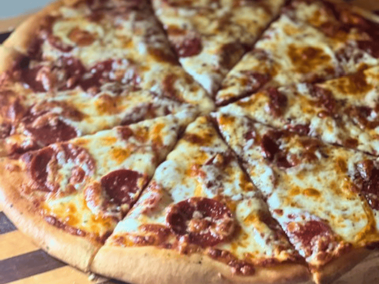 Homemade pepperoni pizza made with scratch-made pizza dough, melted mozzarella cheese, and crispy pepperoni slices baked until golden brown.